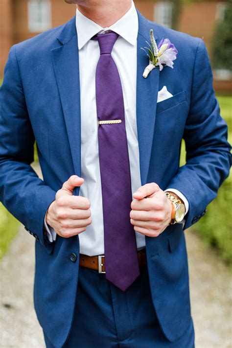 blue suit with purple tie.